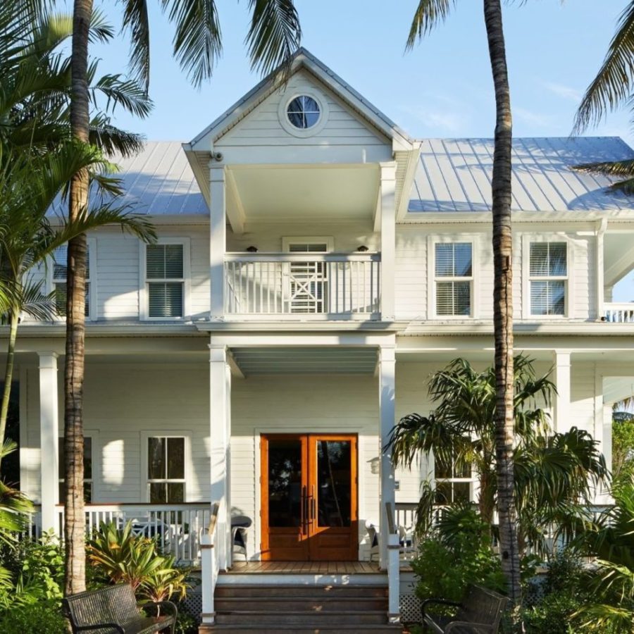 a palm tree in front of a house
