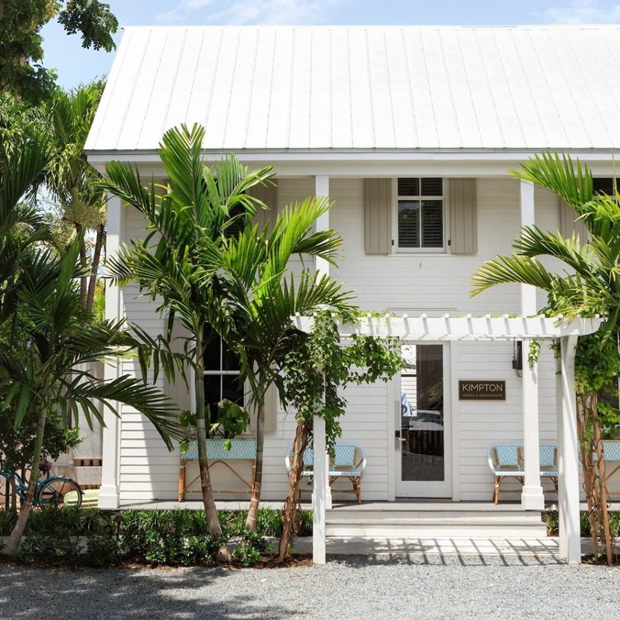 a house with bushes in front of a building