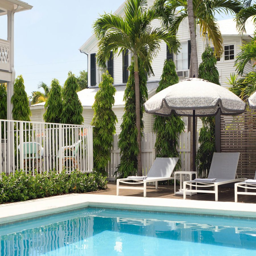 resort with a pool and beach chairs
